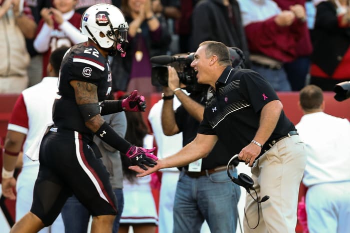 Shawn Elliott high-fives an offensive player running back to the sidelines after a touchdown (17th Oct., 2015)